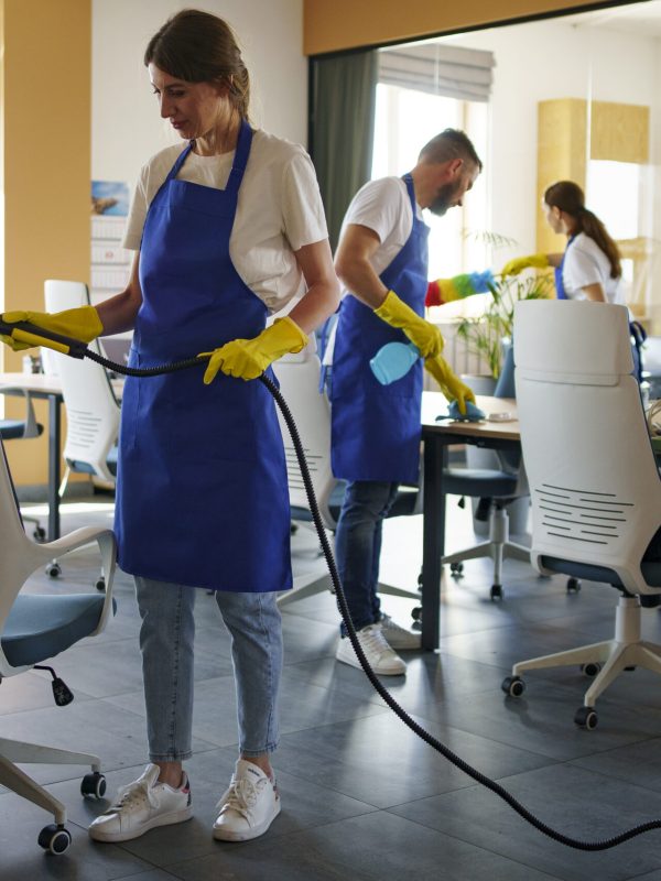 professional-cleaning-service-person-using-vacuum-cleaner-office